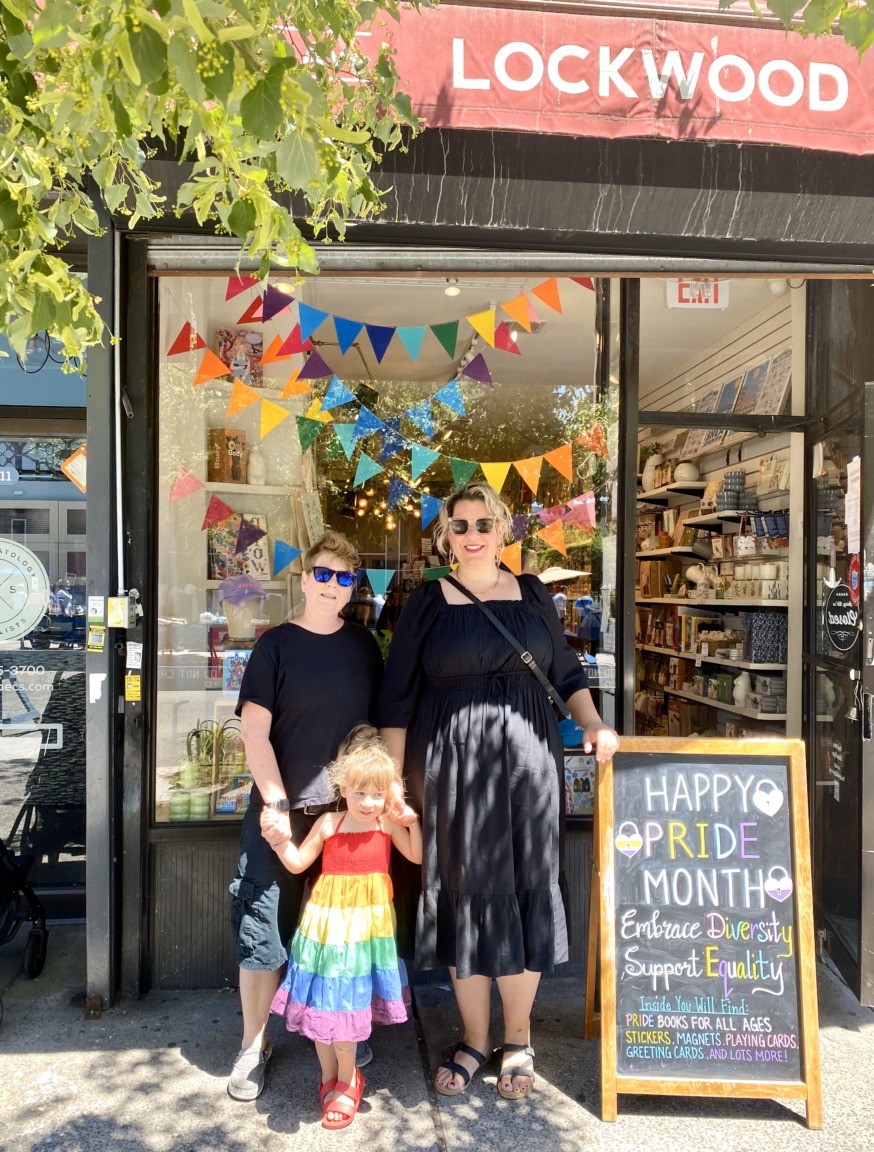 Mackenzi Farquer, (r.) with her wife and their daughter outside the Lockwood store in Jackson Heights (Photo provided)